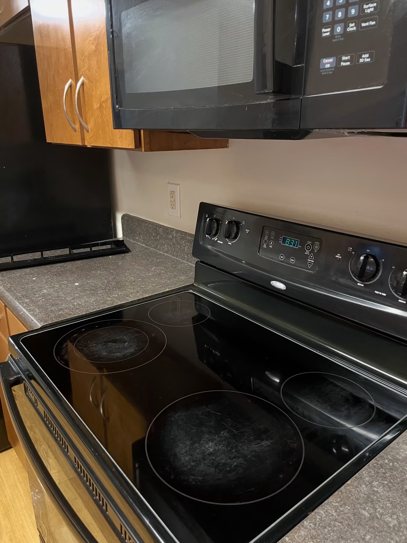 After cleaning: same black glass stovetop degreased and buffed to a reflective shine by Clean & Polished